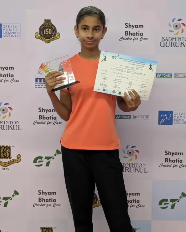 One of our star players from the Chembur Gymkhana center posing with her bronze medal and certificate from the Yonex Sunrise Gautam Thakkar Memorial Sub-Junior Badminton Tournament.