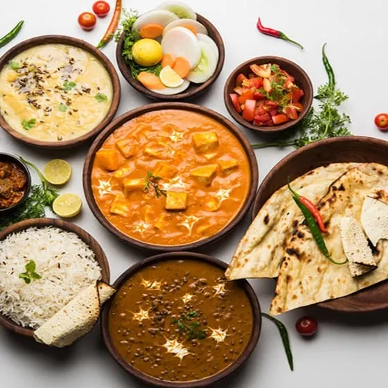 This is the kind of delicious, 100% vegetarian North Indian spread we can prepare for your event. It features a variety of our popular dishes like paneer curry, dal makhani, jeera rice, and fresh salad, all made with balanced spices.