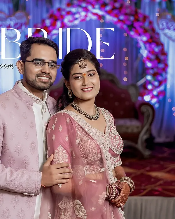 Deepa and Pawan in a classic portrait against their vibrant event decor. This shot balances a formal pose with their natural, happy expressions.