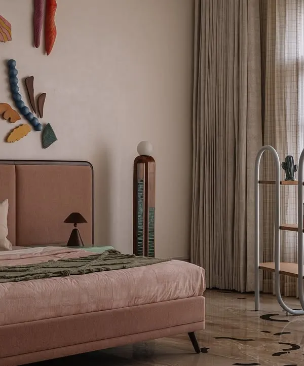 The showstopper of this bedroom is the 'Love is a Wave' wall installation, a collaboration with a talented artist. The collection of handcrafted ceramic pieces evokes the serenity of the ocean, turning the wall behind the bed into a captivating art piece.