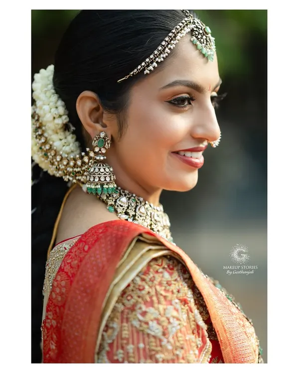 A profile view of Likitha's regal wedding look. This showcases the importance of creating a balanced side profile, ensuring the hair, jewelry, and makeup work in perfect harmony.