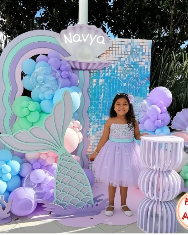 I specialize in creating immersive worlds for children's birthdays. This 'Under the Sea' mermaid theme for Navya's party featured a custom backdrop with pastel balloons, shimmering details, and adorable sea creature cutouts for a truly magical photo corner.