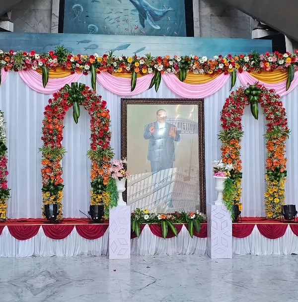 This is the full view of a stage I designed for a formal tribute at ONGC. The symmetrical design with four floral arches and a clean, draped backdrop ensures a professional and dignified look suitable for any corporate or government event.