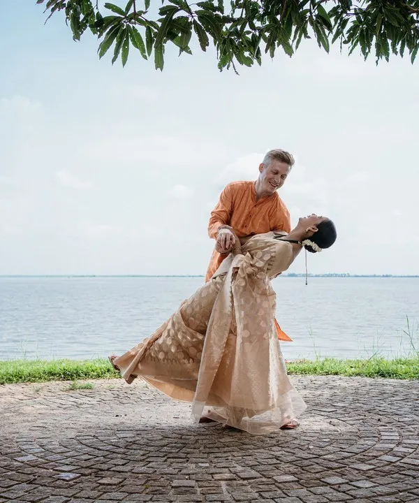 A romantic dip against the serene backwaters of Kerala, showcasing a beautiful destination wedding. I plan weddings not just in Bangalore, but also in stunning locales like Coorg, Mysore, and Kerala.