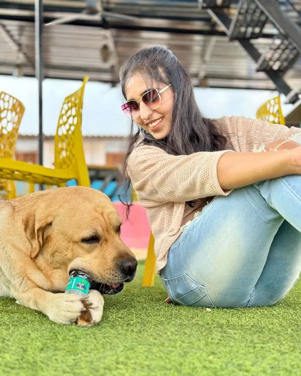 Just a girl and her best friend, chilling on the lawn. This is the relaxed, happy vibe we strive for every day.