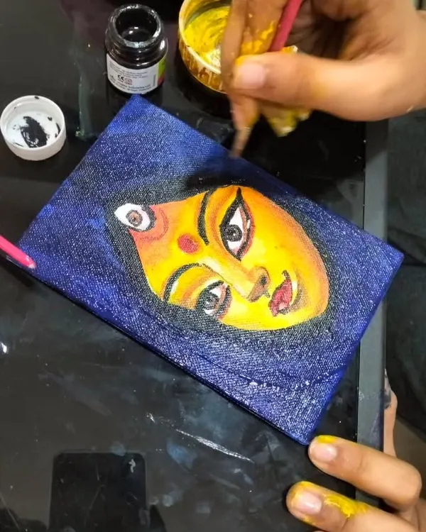 A close up of a beautiful canvas painting in progress. Our art classes allow kids to explore different mediums and techniques, creating wonderful pieces like this expressive face.