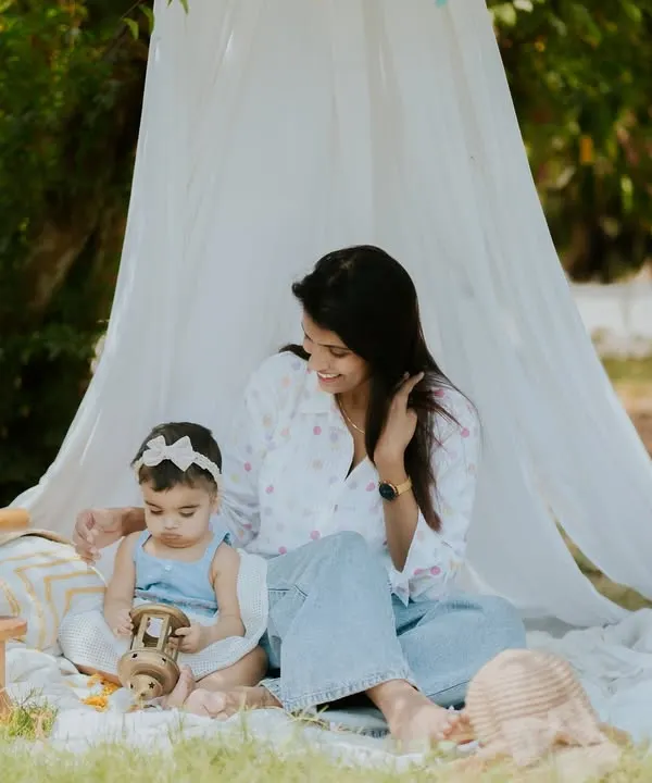 A quiet moment between a mother and her baby during an outdoor picnic session. The peaceful setting is perfect for capturing these gentle interactions.