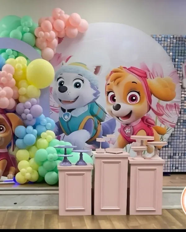 A vibrant Paw Patrol theme for a third birthday, featuring Skye and Everest. The setup includes pastel rainbow balloon arches and character cutouts, creating a perfect stage for the little one's big day.