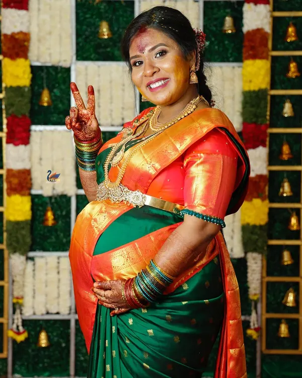 A joyful portrait of the mother-to-be during her baby shower ceremony, dressed in a beautiful silk saree. I focus on capturing the happiness and glow of this special day.