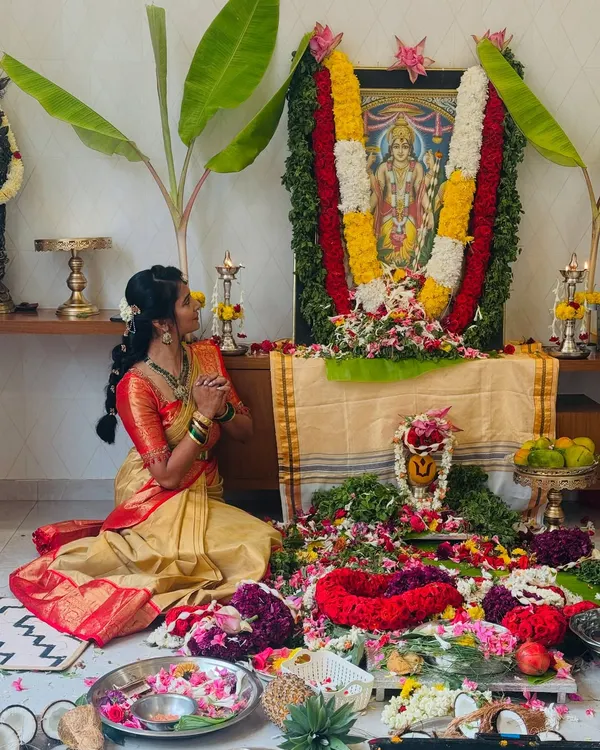 Dressed in a traditional saree, I find a deep connection between my culture and my yoga practice. Here I am in a moment of prayer during a family pooja.
