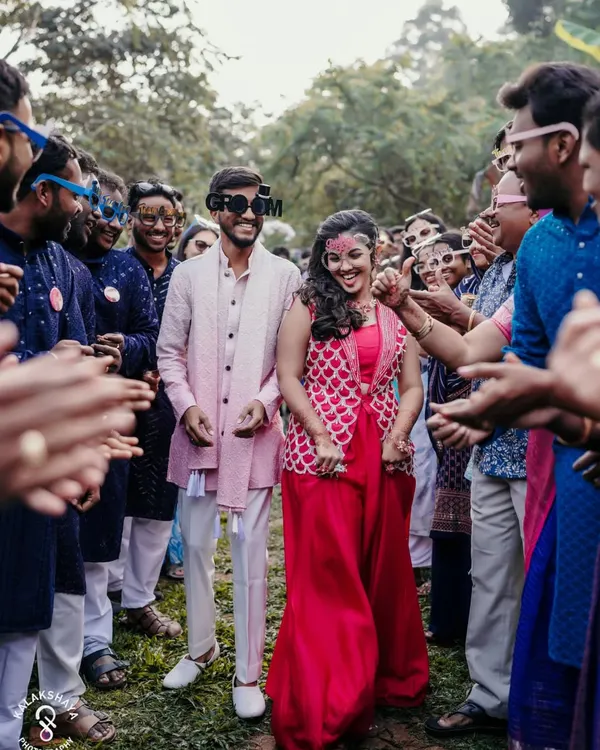 The grand entrance! Capturing the couple's joyful arrival at their Haldi party, surrounded by friends and family.
