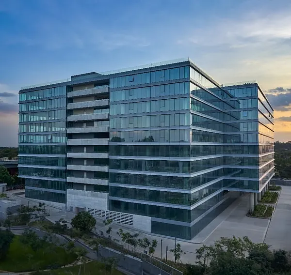 An aerial view of the Godrej Centre Development, showcasing its significant scale and the strategic massing of its glass-clad volumes. The design integrates rejuvenating balconies and green buffers to soften the building's presence in the urban landscape.