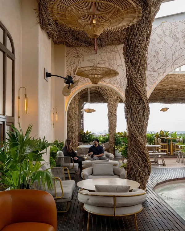 Another view of the Nido rooftop bar, showcasing the interplay between the handwoven lantana ceiling and the open sky. We designed this space to feel like a natural escape, with comfortable lounge seating perfect for conversations.