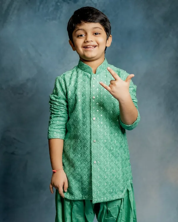 Rock on. This little star is all smiles in our mint green Patiala set. This collection blends timeless tradition with playful charm, perfect for lighting up any room.