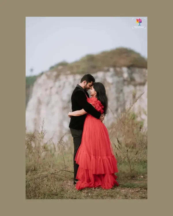 A fairytale moment captured against a raw, natural backdrop. The contrast between the elegant red gown and the rugged landscape creates a powerful, romantic image that feels both grand and intimate. This is the kind of cinematic storytelling I love to create.