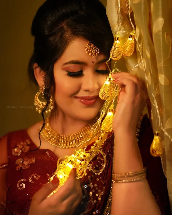A festive portrait for a makeup artist collaboration. The warm fairy lights add a magical glow, highlighting the beautiful makeup and jewelry.