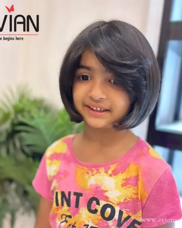A beautiful shot of this little girl's new bob haircut. The style is neat, chic, and perfect for keeping her hair healthy and out of her eyes.