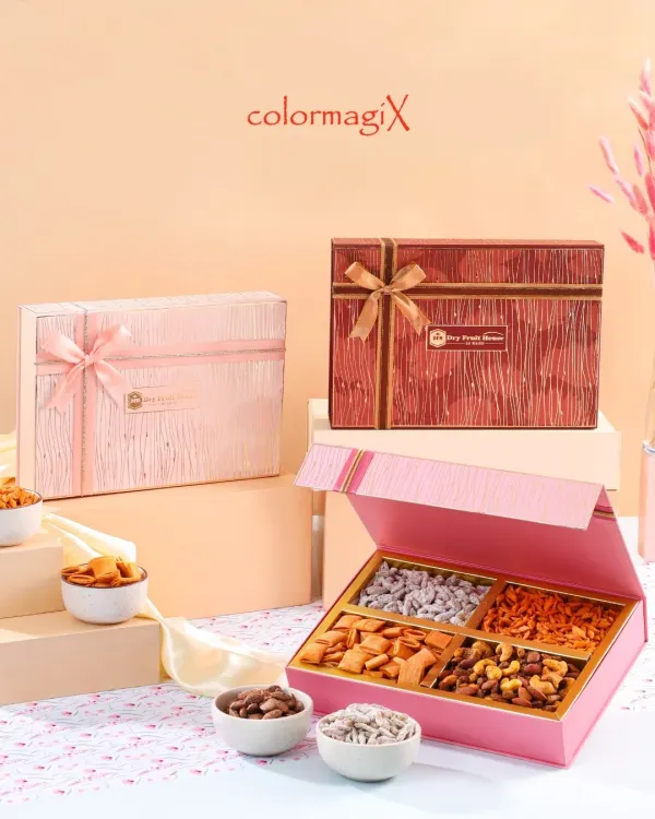 Our luxury dry fruit boxes are a celebration of health and elegance. This image showcases two color options, pink and red, with the box opened to reveal a neat assortment of premium nuts and dried fruits.