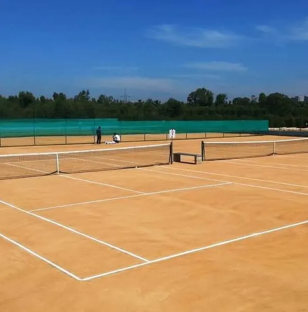 A clear view of one of our five championship-level clay courts on a perfect day for tennis. We keep the surface pristine and the lines sharp, ready for your next match or corporate tennis tournament in Bangalore.