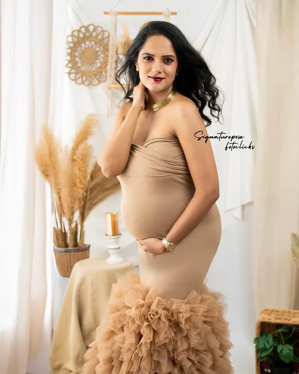 This portrait showcases one of my favorite boho looks, a form-fitting gown with a dramatic ruffled train, set against our earthy-toned backdrop.