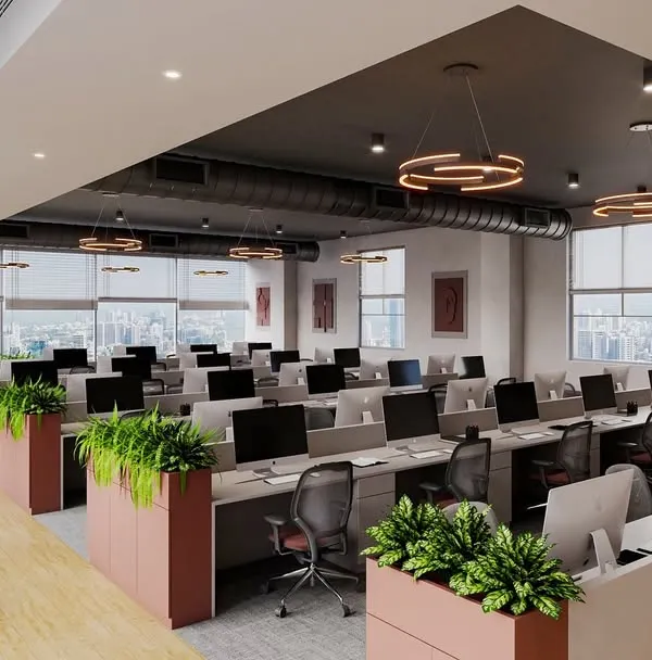 A wide view of a completed office in Pune, where we integrated the brand's red and grey colors into the design. The space combines open workstations with planters that act as natural dividers, promoting a collaborative yet organized atmosphere.
