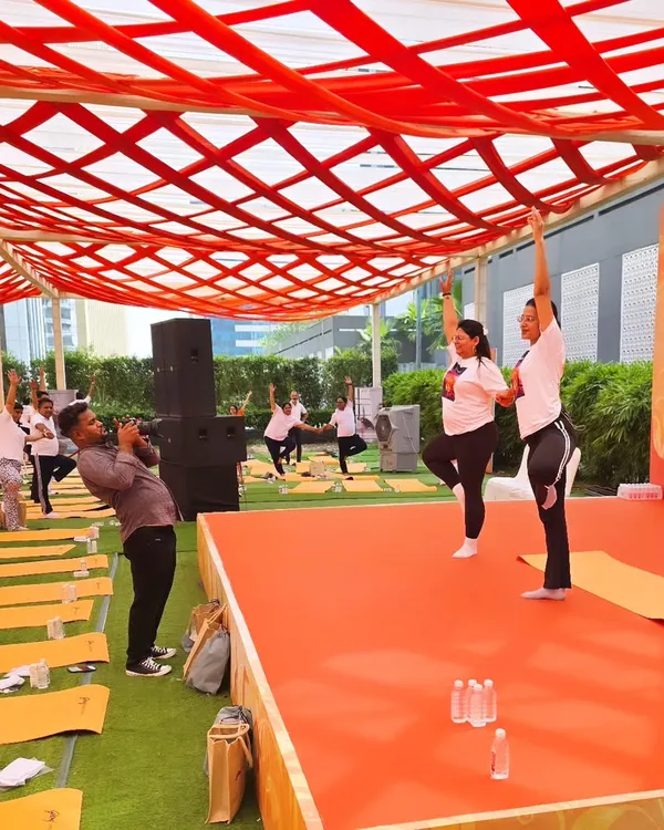 Leading a session on stage during a corporate wellness event. I enjoy guiding large groups and making yoga accessible and enjoyable for everyone, regardless of their experience level.