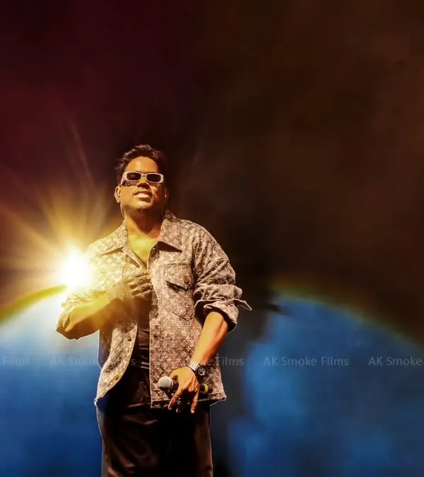 A powerful hero shot of musician Yuvan Shankar Raja, illuminated by a single starburst of light against a smoky backdrop. This image showcases our ability to create dramatic and iconic concert photos.