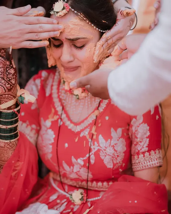 An emotional and powerful moment as the bride is moved to tears while receiving blessings and haldi from her loved ones. These are the raw, real moments I strive to capture.