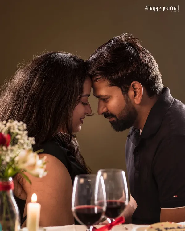 A romantic, candlelit moment for a couple. This photo captures the intimacy and love shared between two people, perfect for an anniversary celebration.