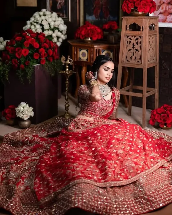 A regal reception look. This bride is wearing a magnificent red lehenga, and we paired it with a soft glam makeup look to keep it elegant and timeless.