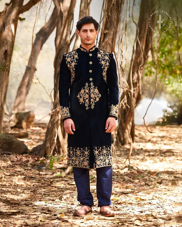 This is pure royalty. A deep navy velvet sherwani with intricate gold embroidery on the shoulders, cuffs, and hem. It’s a powerful, regal look for a groom who wants to command attention at his wedding or reception.