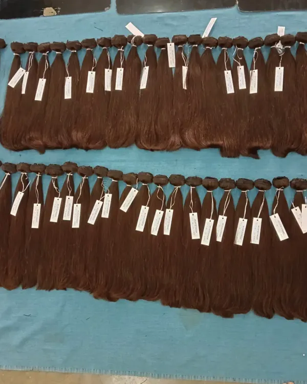 Here is a fresh batch of high-quality dark brown human hair, tagged and ready for my wholesale partners. Running a factory means I can ensure a consistent supply of popular products for your business.