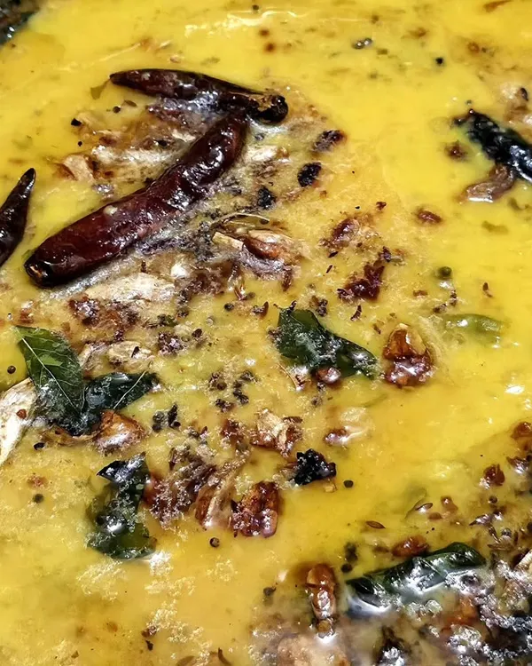 A close-up of our flavorful dal tadka, tempered with red chilies, curry leaves, and spices. A staple of our vegetarian catering menu.