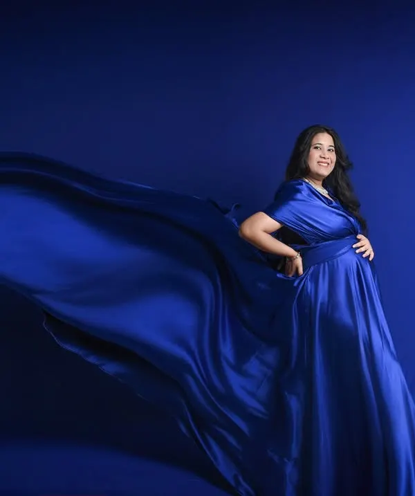 The beauty of a fabric toss. This technique adds movement and a 'wow' factor to your maternity photos, turning a simple pose into a work of art.