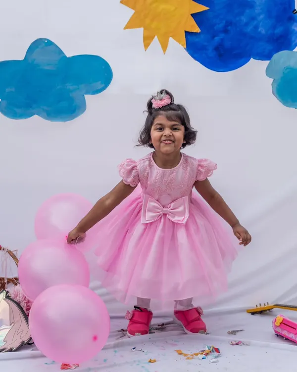 This is what pure joy looks like. I designed this pink tulle party dress for twirling, celebrating, and making unforgettable birthday memories. The layered skirt is light and airy, while the embroidered bodice adds a touch of princess magic.
