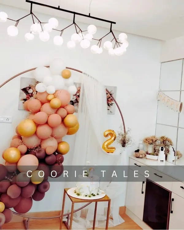 Celebrating a second birthday with a chic at-home setup. This design shows how we can transform any space with a stylish balloon arch in a warm, autumnal color palette and a modern circular backdrop.