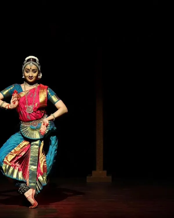 A graceful pose from the Kanasu Dance Event. The minimal lighting focuses all attention on the dancer's form and expression.