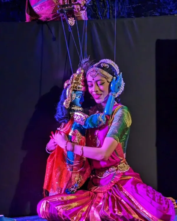 We believe puppetry is poetry in motion. This image captures a tender moment between a puppeteer and her creation during our "Poetry in Puppetry" show, showcasing the deep emotional connection that is at the heart of our storytelling.
