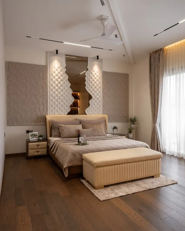 This master bedroom is a study in texture and tranquility. The unique 3D panel behind the bed creates a sculptural focal point, while the warm wooden floors and soft, neutral bedding invite rest. Every element is designed to soothe the senses and create a deeply personal sanctuary.