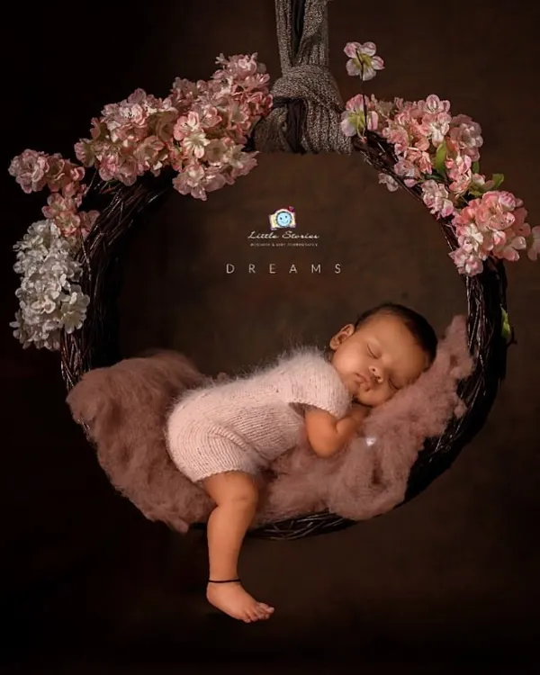 This portrait captures the dreamy, fine art style I love to create. I used a custom-made floral wreath swing and soft lighting to create a magical, peaceful scene for this sleeping newborn.
