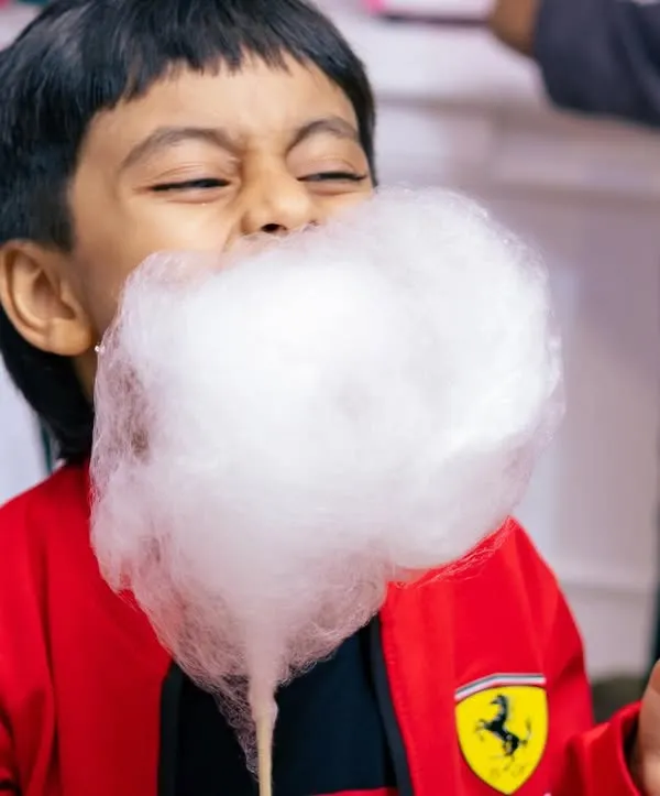This is the moment we live for. Pure, unfiltered joy as a young guest enjoys a fluffy cloud of our organic cotton candy. We bring these happy moments to every event.