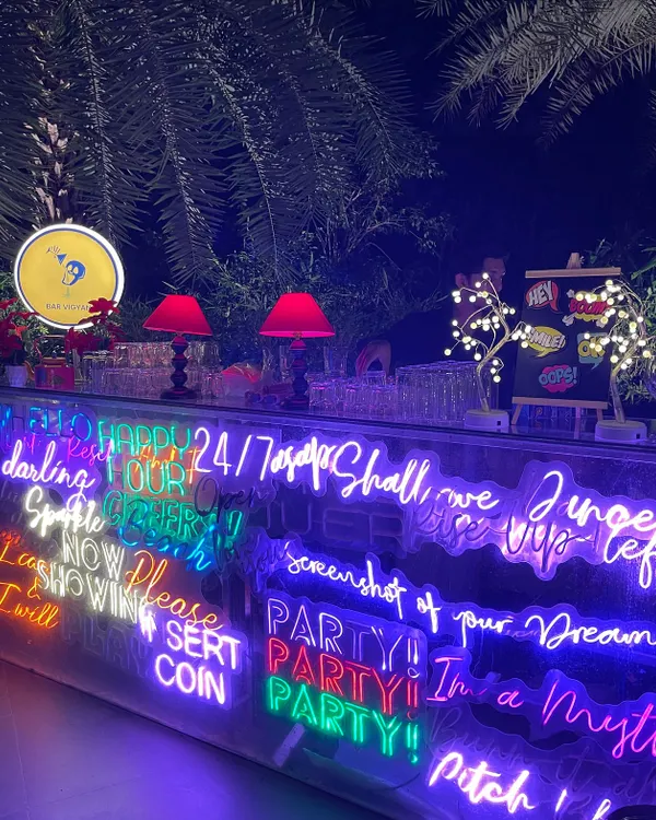 A full view of the custom neon bar I designed for a private birthday party. The bright, overlapping text creates a dynamic and modern focal point for the celebration.
