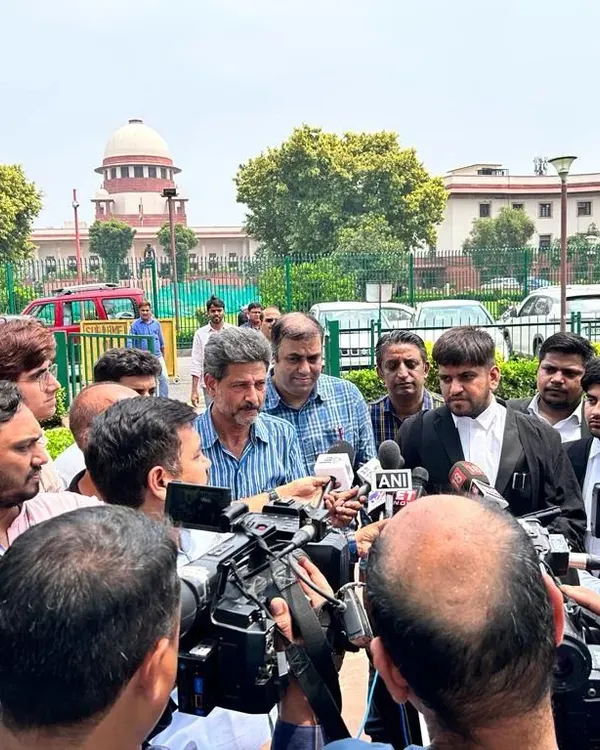 Surrounded by reporters from various national news outlets, including ANI and News18, outside the Supreme Court. I believe it's important to provide clear legal context to the public on high-profile cases.