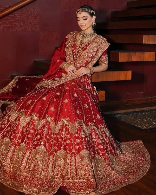 This is the essence of the modern maharani look I love to create. I styled this breathtaking red and gold lehenga from Akriti by Shakun to highlight its royal silhouette and intricate embroidery, ensuring the bride felt nothing less than regal on her main day.