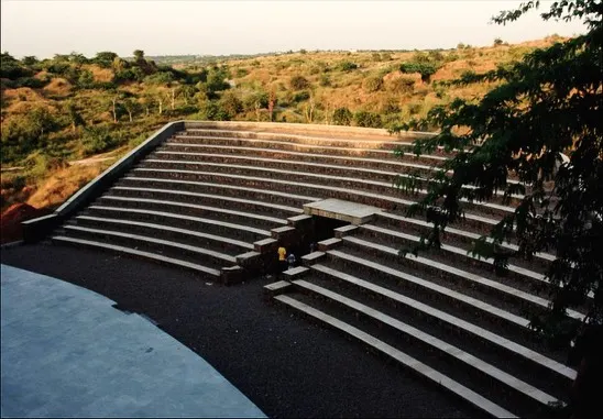 The Aravali Biodiversity Park Amphitheatre in Gurgaon is carved into the natural slope of the land. The seating is created using gabion walls filled with locally sourced stone, making it a sustainable structure that blends seamlessly with the rugged landscape.