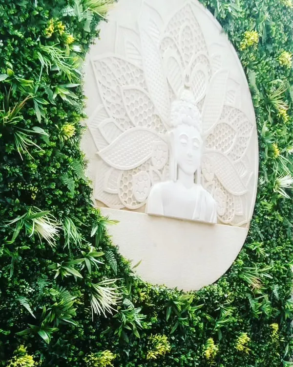 A unique feature wall I created using an artificial vertical garden with a custom white Buddha relief sculpture at its center. This is a powerful statement piece for an entryway or a reception area.