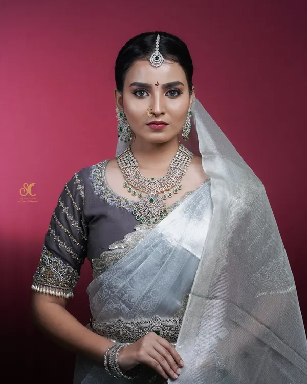 An ethereal Muhurtham look created for a makeup academy's professional course. The studio lighting is set up to accentuate the fine details of the diamond jewelry and the texture of the grey saree.