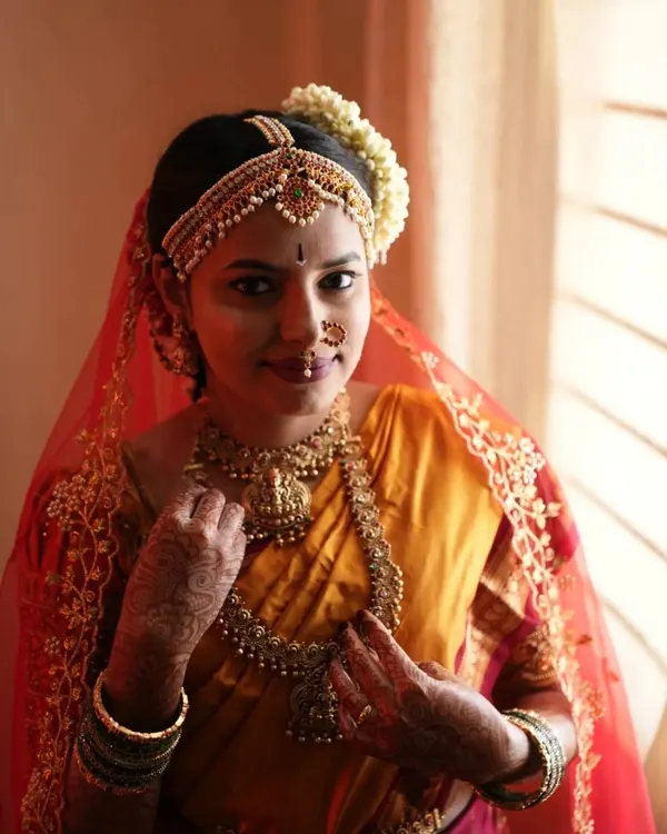 A portrait of bride Yashwini on her wedding day. This look features classic elements of a Brahmin bride, with emphasis on the eyes and traditional jewelry, ensuring the makeup is both beautiful and culturally significant.