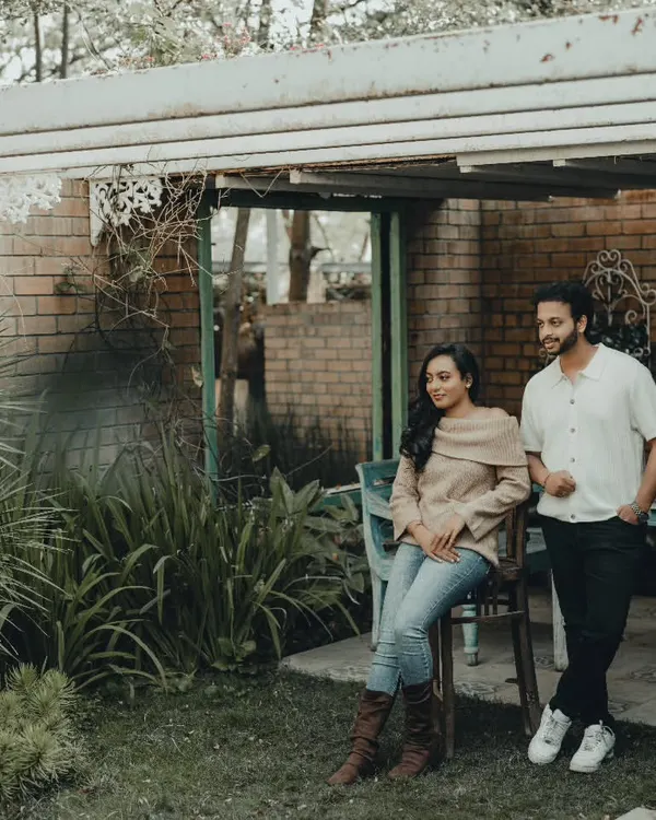 A quiet, candid moment during a pre-wedding shoot in a rustic garden setting. I focus on finding beautiful light and natural interactions between the couple.