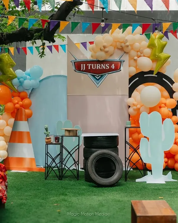 Welcome to the race track. We designed this entire setup for a 4th birthday, transforming the space into the world of 'Cars' for a truly immersive party experience.
